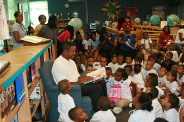 Brian Jordan reading to the youth.